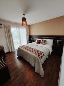 a bedroom with a large bed in a room at Posada Piedramora in Mina Clavero