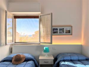 Ένα ή περισσότερα κρεβάτια σε δωμάτιο στο Sabbia Dorata