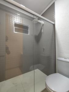 a bathroom with a glass shower with a toilet at Angel Hospedagem de quartos Self Check in in Vila Velha +55 photos