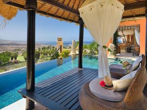 a villa with a view of a swimming pool at Royal Garden Villas, Luxury Hotel in Adeje