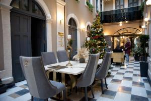 a dining room with a christmas tree and a table and chairs at Ferman Port Hotel - Special Category in Istanbul