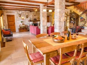 a dining room with a wooden table and chairs at Villa Slivari in Žminj