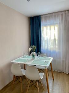 a table with wine glasses and a vase with flowers at Apartment in Studenets, Pamporovo in Pamporovo