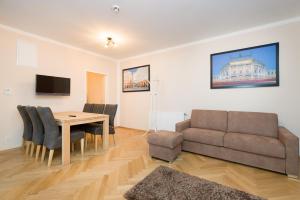 a living room with a table and a couch at Vienna Stay Apartments Schönbrunn in Vienna