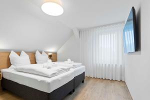 Postel nebo postele na pokoji v ubytování Hotel Garni Traube