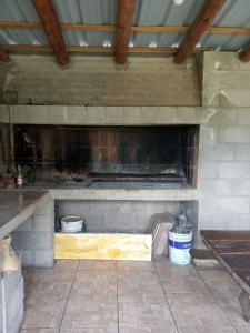 a kitchen with a stone fireplace in a building at Casas Cordoba in Villa Parque Siquiman