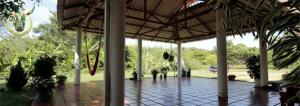 a pavilion with a tiled floor and a roof at Posada Hato el Diamante in San Luis de Palenque