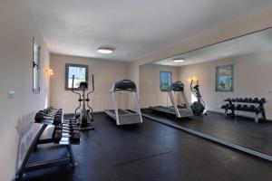 a gym with several exercise bikes and a mirror at Carme Villas in Adelianos Kampos