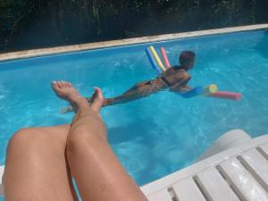 a man in a swimming pool playing with toys at Merlo2 in Merlo