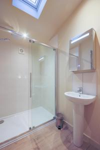 a bathroom with a glass shower and a sink at Balloch Park in Aberfeldy