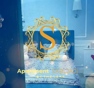 a sign on top of a bed in a room at Apartment Sabljaci by the Lake in Ogulin