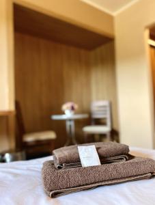 una pila de toallas sentadas encima de una cama en Penzión Kingo, en Nemšová