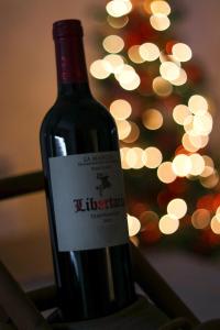 a bottle of wine with a christmas tree in the background at Apartment '84 in Pale +19 photos
