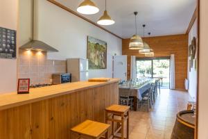 a kitchen with a long counter and a dining room at Domaine Sur-Valot in Beaubery