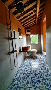 a bathroom with a toilet and a tile floor at Toong homestay in Ha Giang