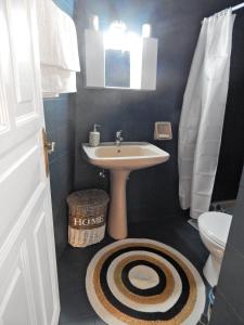 a bathroom with a sink and a toilet at Cozy 2 Bedrooms Apartment on the Hill w/Netflix in Karousádes