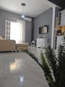 a living room with a couch and a plant at Cozy 2 Bedrooms Apartment on the Hill w/Netflix in Karousádes