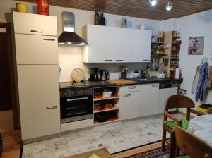 a kitchen with a stove and a white refrigerator at Urlaub am Auberg in Gerolstein