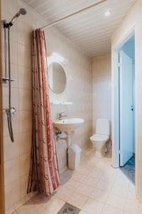 a bathroom with a sink and a toilet and a shower at Staadioni Hotel in Kuressaare