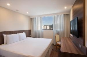 Postel nebo postele na pokoji v ubytování Windsor Tower Hotel