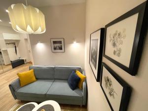 a living room with a couch and pictures on the wall at Cozy Home Jekaba Apartment, old town, self check-in in Riga