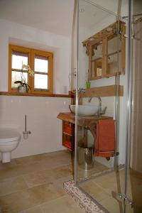 a bathroom with a sink and a toilet at Mühle zu Waching in Brannenburg