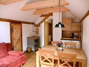 a living room and dining room with a table and chairs at Mühle zu Waching in Brannenburg