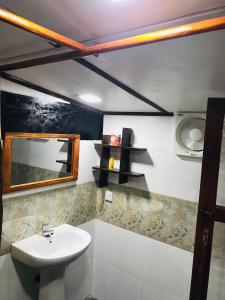 a bathroom with a sink and a mirror at Ritigala Hideaway in Habarana