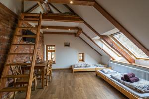 a room with a loft with a staircase and a table at Villa Hubertus in Srebrna Góra