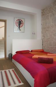 a bedroom with two beds with red and orange sheets at Luxury Villa Roza in Split