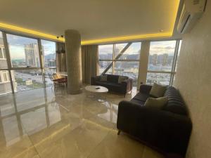 a living room with couches and a large window at Le Luxe Suites Hotel & Spa in Bursa