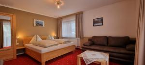 A bed or beds in a room at Pension Schweizerhof