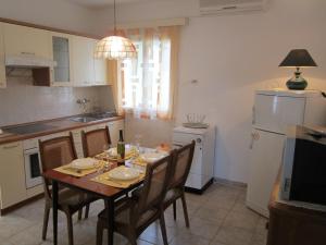 a kitchen with a table with chairs and a dining room at Apartment Tisno Residence in Tisno