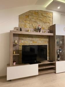 a living room with a large flat screen tv at Milmari Apartman N92 Kopaonik in Kopaonik