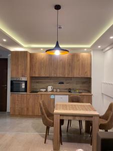 a kitchen with a table and a dining room at Milmari Apartman N92 Kopaonik in Kopaonik