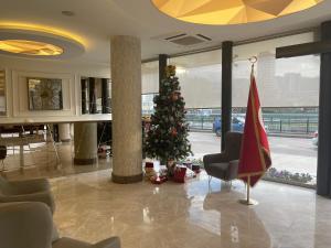 a christmas tree in the lobby of a building at Le Luxe Suites Hotel & Spa in Bursa