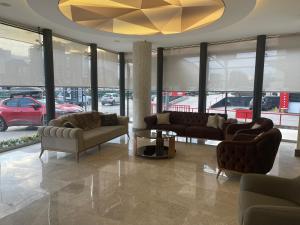 una sala de estar con sofás y una lámpara de araña. en Le Luxe Suites Hotel & Spa, en Bursa