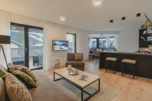 a living room with a couch and a table at Bergkranz Apartments in Seefeld in Tirol