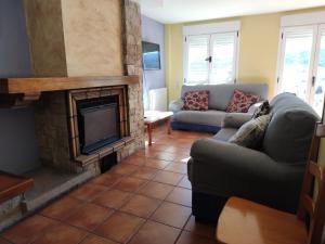 a living room with a couch and a fireplace at Casa de la Hiedra Soria in Soria