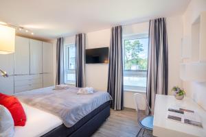 1 dormitorio con cama y ventana grande en Appartement "Traumzeit" mit Penthouseflair - Oase am Haff, en Garz