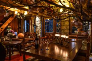 a dining room with a table with wine glasses at Hotel Polydrosos in Polydrossos