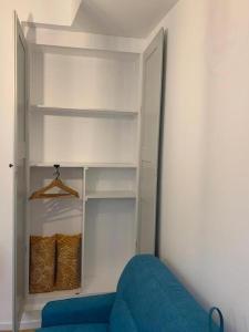 a closet with a blue couch in a room at Les Tiercelines in Dole