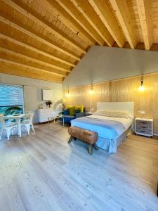 a large bedroom with a bed and a table at Aloia Nature, Alojamiento Forestal in Tui