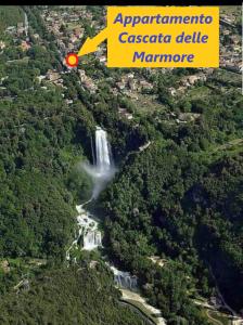 a waterfall in the middle of a forest with a red arrow at Appartamento Cascate delle Marmore in Le Marmore