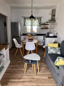 a kitchen and living room with a table and a couch at Casa Lela II in Fuencaliente de la Palma