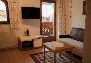 a living room with a couch and a window at Apart Daniel in Ried im Oberinntal