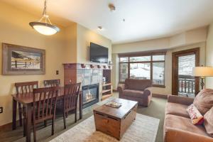 a living room with a couch and a table at Ski In Ski Out Conde Nast and Forbes Award Winner One Bedroom View Pool Hot Tub in Park City