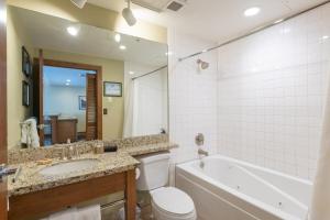a bathroom with a tub and a toilet and a sink at Ski In Ski Out Conde Nast and Forbes Award Winner One Bedroom View Pool Hot Tub in Park City