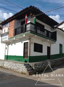 a house with a balcony on top of it at Hostal Diana in San Agust&iacute;n