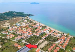 an aerial view of a city with a red arrow at Private 6-bdrm Villa with garden 150m to beach in Paradisos